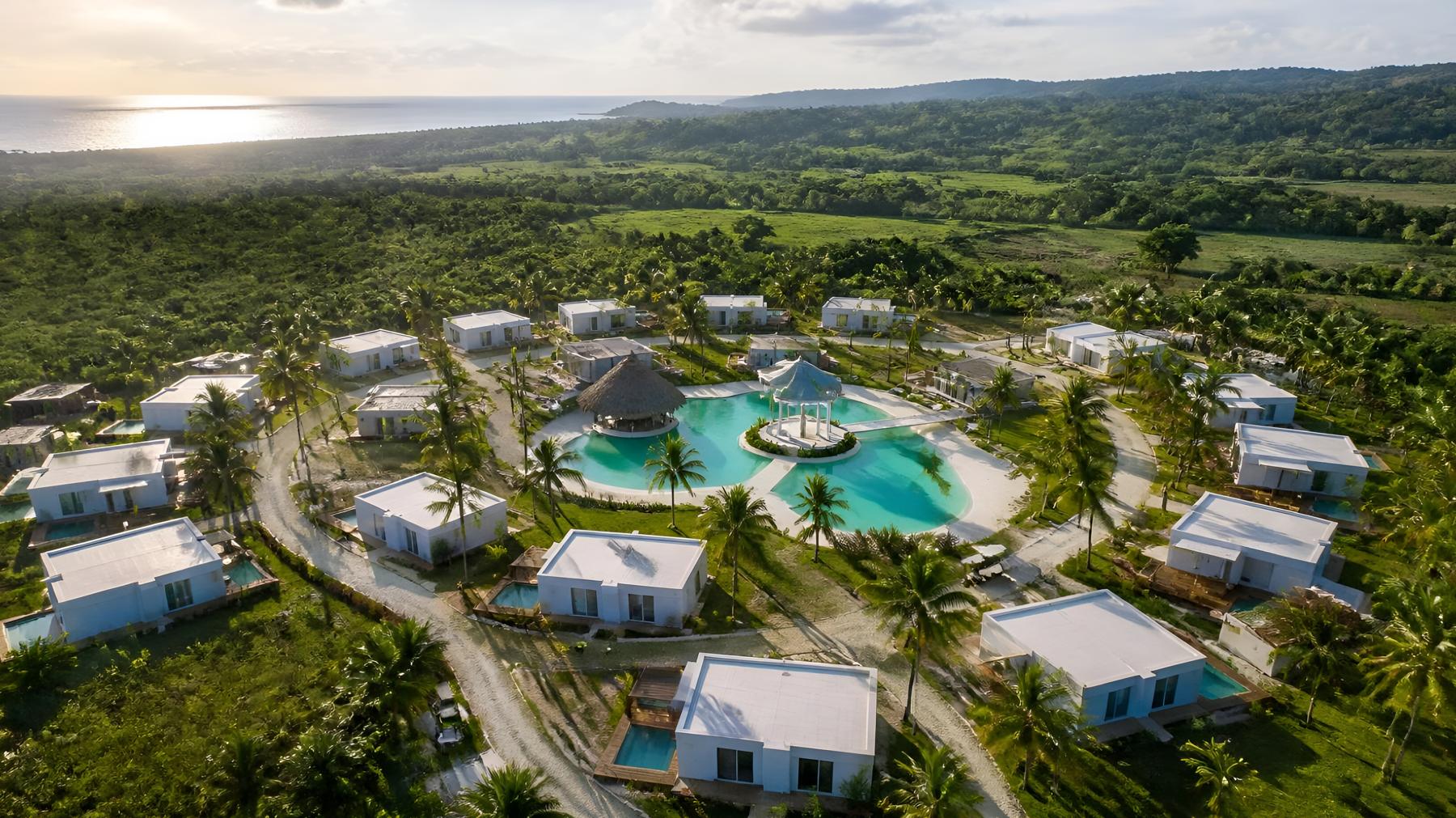 Aerial view of the villas among palms near the coast