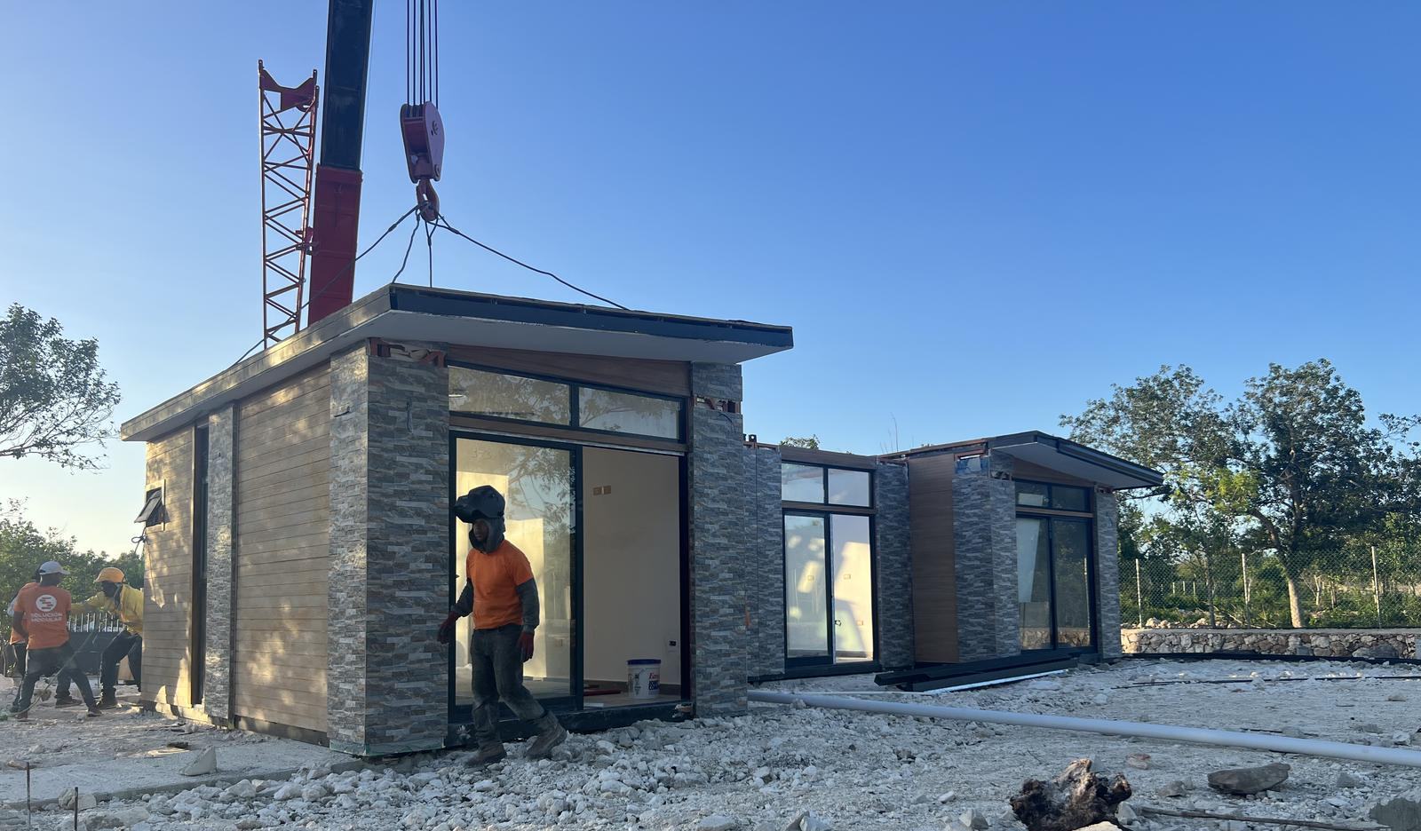 A finished villa craned onto its foundation